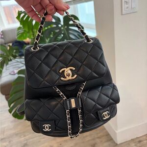 CHANEL Black Quilted Backpack with Gold Accents